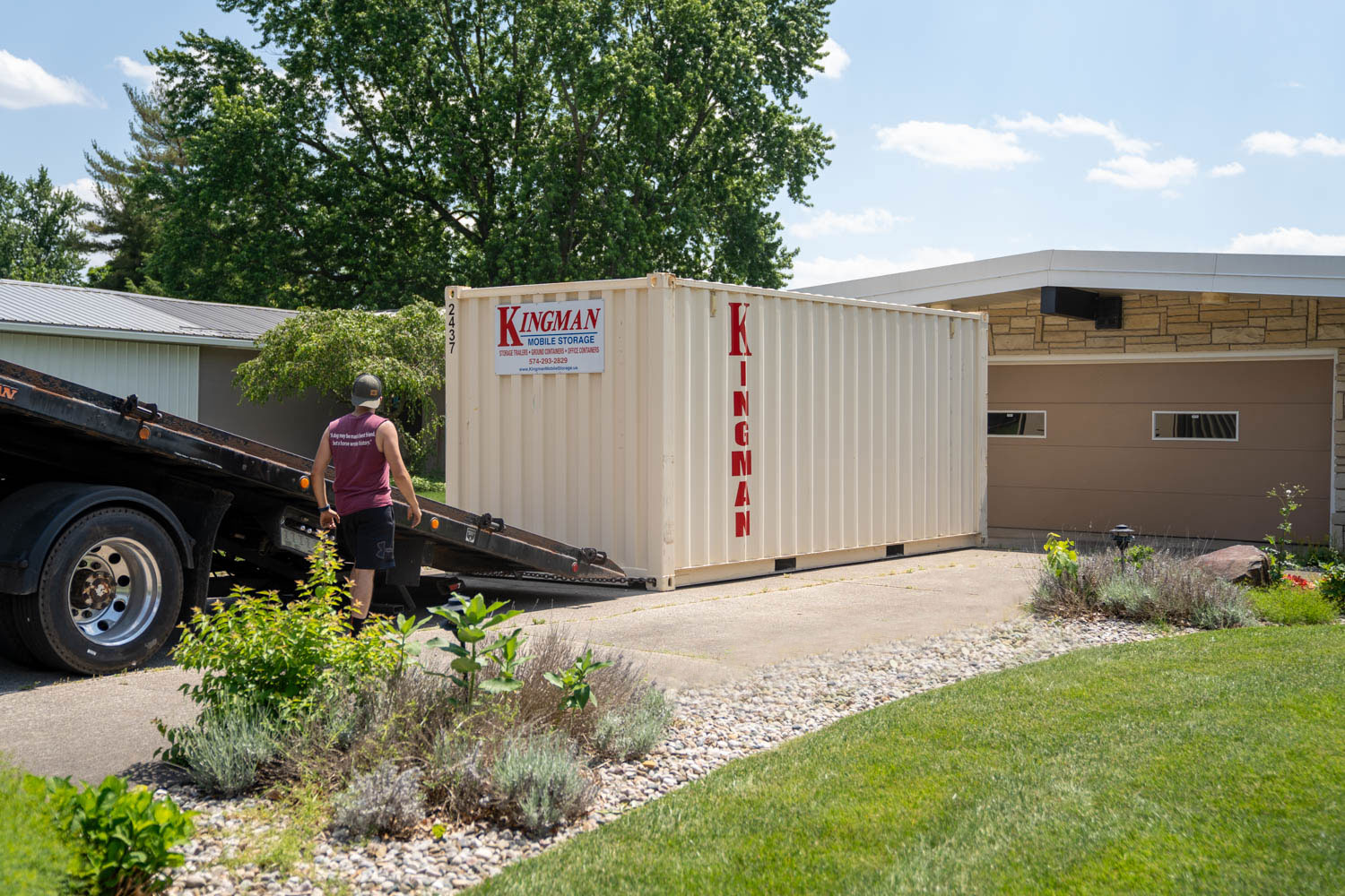 20 foot storage container being unloaded at a residential property