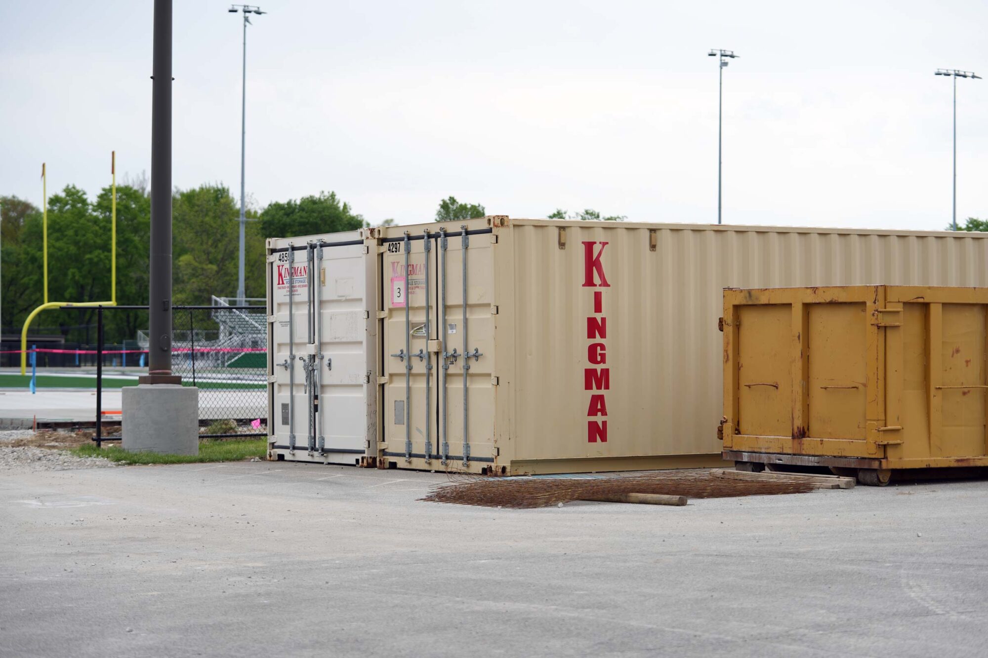 kingman containers sit in front of football field
